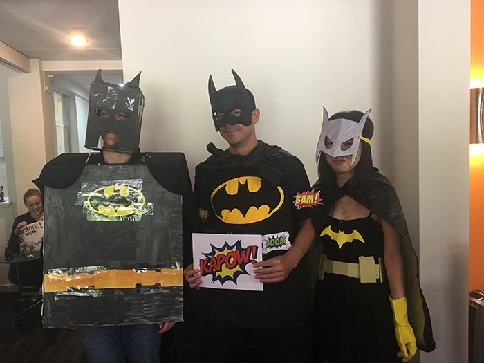 Three people dressed as batman